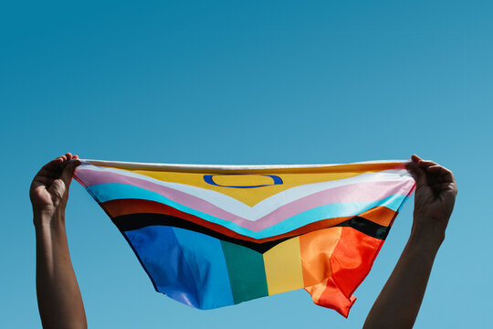 holding an intersex-inclusive progress pride flag