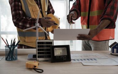 Professional engineering solar planning blueprint with team, Wind turbine and Solar Energy Electrical Engineer concept.