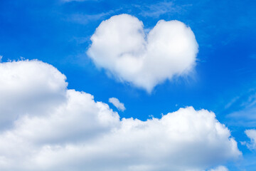 Naklejka na ściany i meble clouds on a blue sky with a heart shaped cloud. horizontal frame