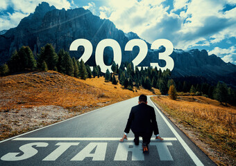 The 2023 New Year journey and future vision concept . Businessman traveling on highway road leading...