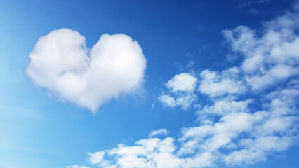 Naklejka na ściany i meble on a blue sky, a heart-shaped cloud with cumulus clouds