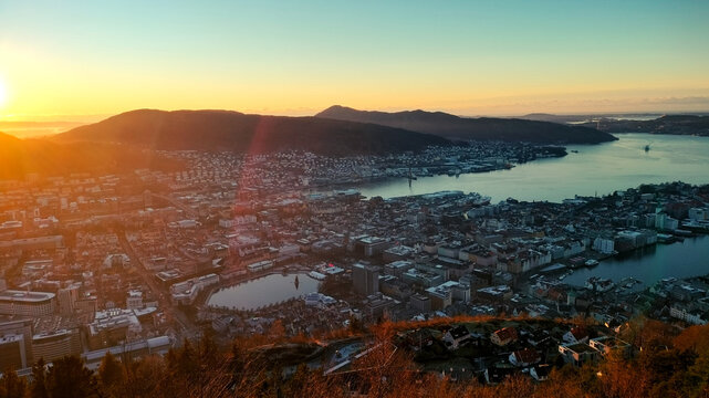 Sunset over the mountains and hills in Bergen, Norway. View from Fløyen, nature, and cityscape in the evening. lakes and streets of the city, hills, and peaks
