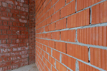 Brickwork of red bricks of different shades and textures in perspective