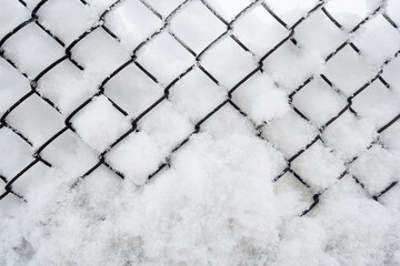 The fence is covered in snow