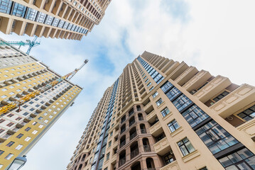 Bottom view towards high-rise buildings and the sky