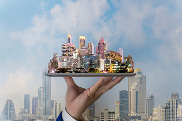 Real estate business concept with city skyline on tablet of urban development that emerges concept.