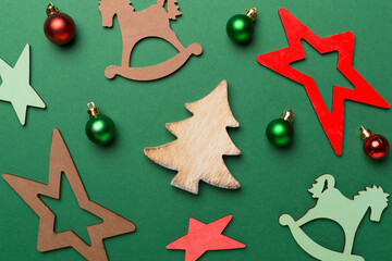Wooden Christmas toys on color background, top view