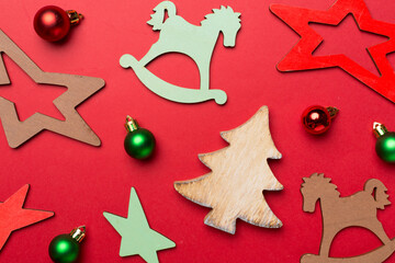 Wooden Christmas toys on color background, top view