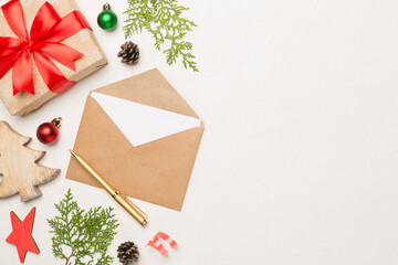 Craft envelope with christmas decoration on concrete background, top view