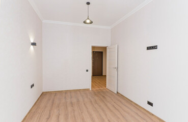 Empty room in light colors after renovation with open door