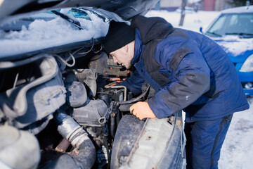 truck van car driver fixing the car in winter on the road. Delivery car breakdown in winter