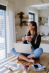 Young woman having homeoffice in her apartment.