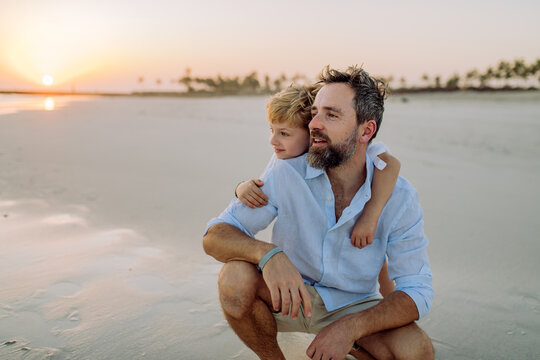 Father with his son enjoying together time at sea.