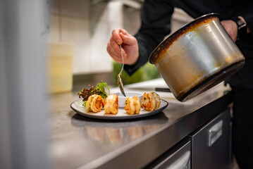 man chef cooking tasty shrimp on kitchen