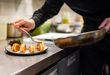man chef cooking tasty shrimp on kitchen