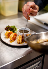 man chef cooking tasty shrimp on kitchen