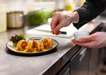 man chef cooking tasty shrimp on kitchen