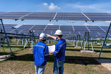 Maintenance engineer at solar farm looking drawing discuss on expansion upgrade electricity plant