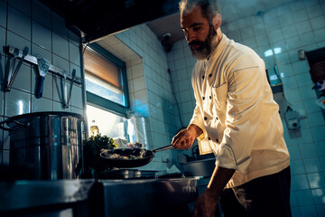 Chef cooking in a commercial kitchen.
