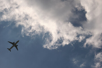 Airplane flying over blue sky and clouds