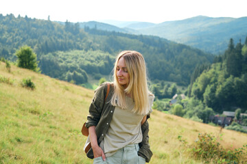Naklejka premium Girl enjoy scenics view on valley. Beautiful nature landscape in mountains. Hiking journey on tourist trail. Outdoor adventure. Travel and exploration. Healthy lifestyle, leisure activities