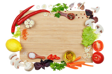 Kitchen cutting board framed with vegetables, herbs and spices. Space for text, top view, mock-up