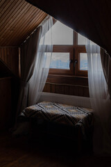 Wooden house inside with big windows. Beautiful view on mountains