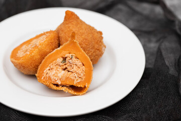 traditional brasilian fried drumsticks Coxinha de frango on dish