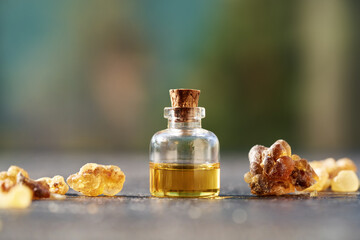 A bottle of frankincense essential oil with frankincense resin