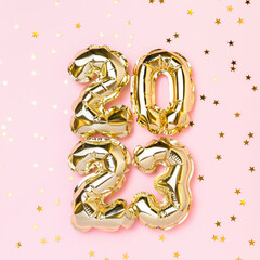 New year 2023 balloon celebration card. Gold foil helium balloon number 2023 and gold confetti...