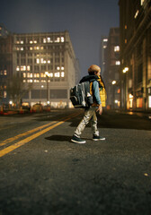 Lone little boy with backpack crosses street in city at night. 3D render.