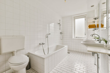 a bathroom with white tiled walls and flooring, along with a bathtub in the center of the room