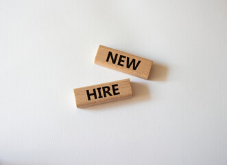 New hire symbol. Wooden blocks with words New hire. Beautiful white background. Business and New hire concept. Copy space.