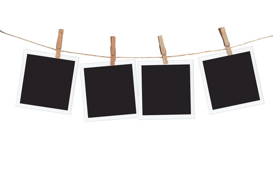 Four blank instant photo frames hanging on a rope, isolated on transparent  background, png file