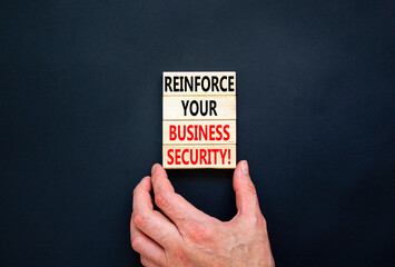 Reinforce your business security symbol. Concept word Reinforce your business security on blocks. Beautiful black table black background. Business reinforce your business security concept. Copy space.