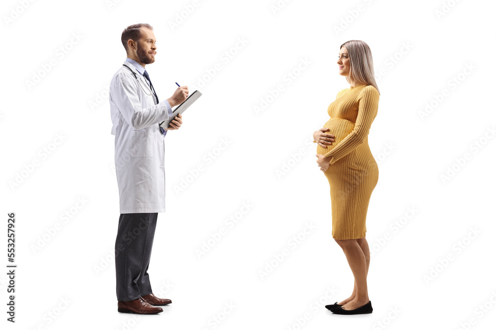 Wall mural Full length profile shot of a doctor writing a document and talking to a pregnant woman