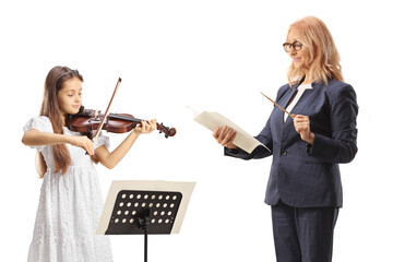 Female music teacher conducting and a schoolgirl playing a violin