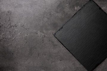 slate cutting board on dark stone background