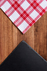 slate on wooden cutting board with red and white checkered cloth