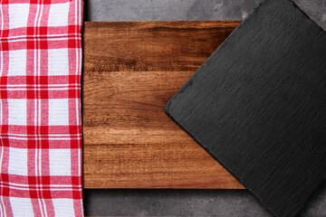 slate on wooden cutting board with red and white checkered cloth