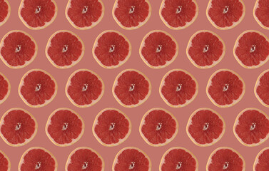 Red grapefruit slices isolated on pink background. Citrus concept idea. 