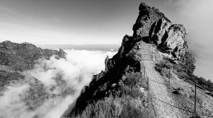 “Ninho da Manta“ panorama near „Pico do Arieiro“ peak, Madeira Island portugal. Narrow mountain ridge with steep precipice both sides the trail. Black and white scenic view on popular hiking path.