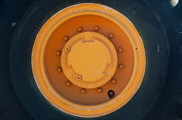 Wheel of heavy wheeled equipment. Excavator wheel with yellow disc.