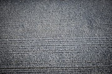 An interesting pattern has formed from a layer of frost that has settled on the top of a wooden picnic table. The resulting scene creates a background that is very wintery 