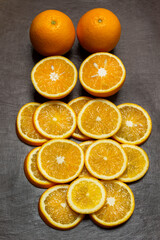 Sliced oranges and two whole oranges.