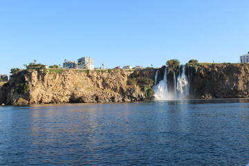 view from the hill to the waterfall pouring into the sea