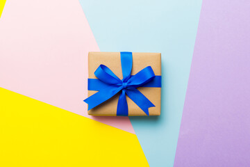 holiday handmade paper present tied blue ribbon bow top view with copy space. Flat lay holiday background. Birthday or christmas present. Christmas gift box concept with copy space