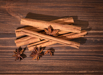 Cinnamon sticks and star anise on wooden background