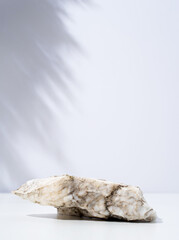 A minimalistic scene of stone marble podium on white background, for natural cosmetics