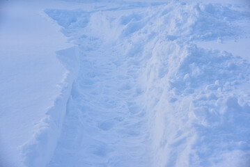 A snow path in a field in winter. White snow path.